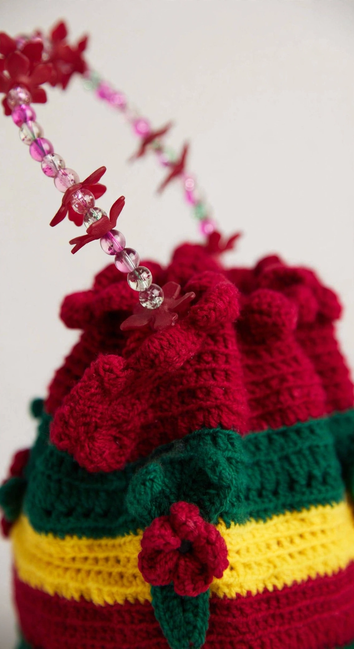 Close-up detail of the Rainbow Bloom crochet drawstring bag's stitches and drawstring